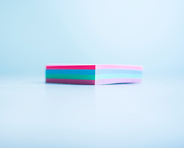 A small stack of multi-coloured sticky notes
